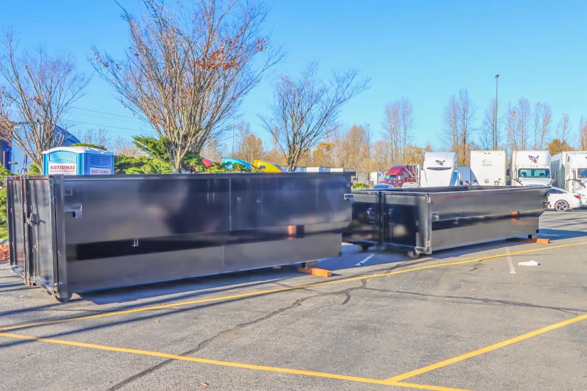 Professional dumpster rental service with roll-off container on residential driveway in Scarborough